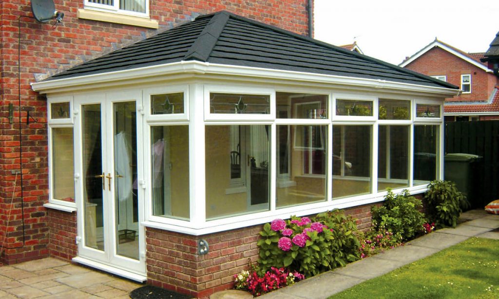 White uPVC conservatory with a black tiled roof